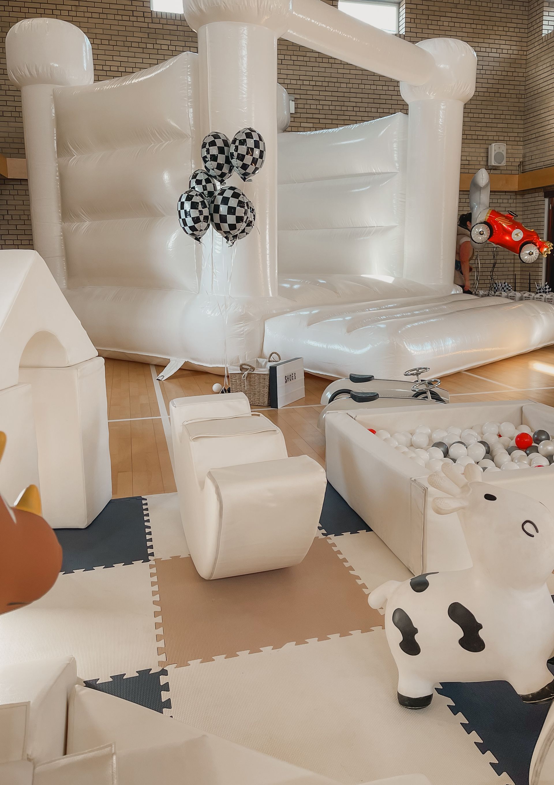 A room with a bouncy castle and a ball pit.