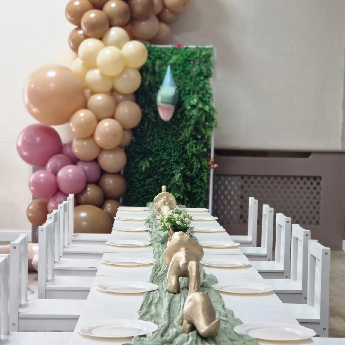 A long table with plates and balloons on it