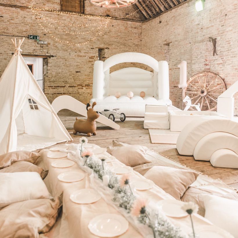 A room with a bouncy castle and a teepee