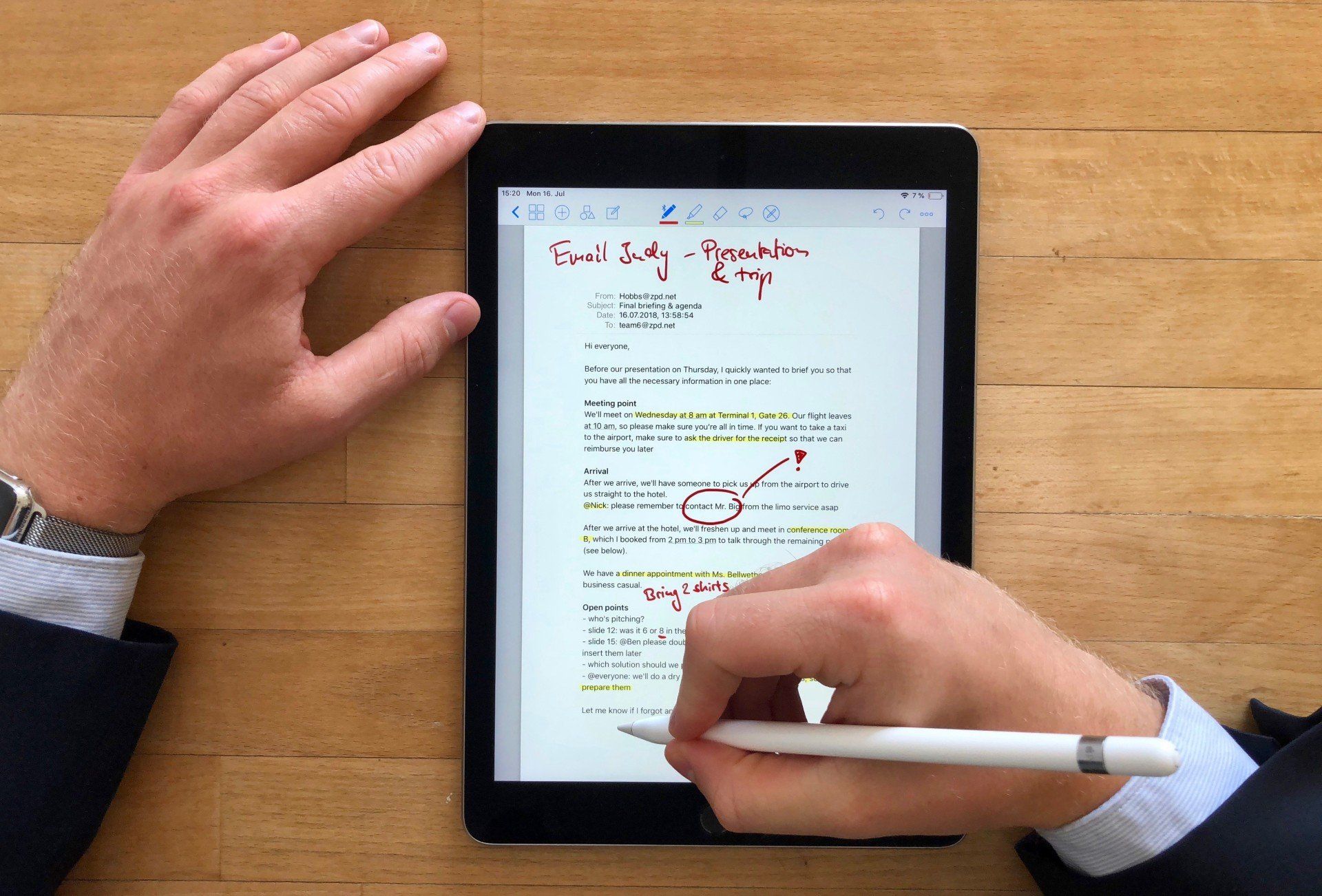Picture of a person using an apple pencil on an iPad to mark up a document