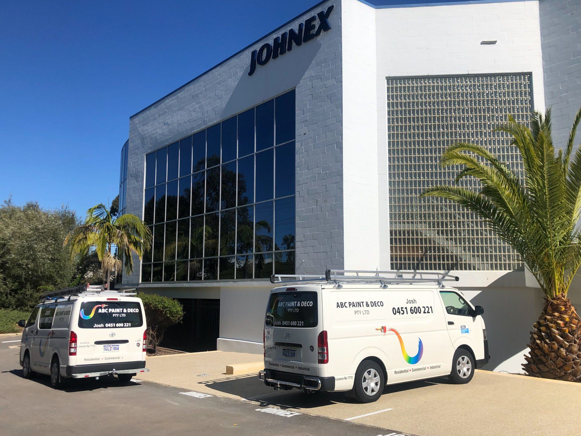 ABC Paint & Deco vans outside large commercail building in perth