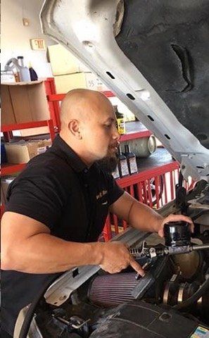 Mechanic Examining Underside of Car — La Porte, TX — Kwik Kar Oil & Brake