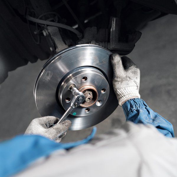 Car Mechanic Hands Replace Brakes — La Porte, TX — Kwik Kar Oil & Brake