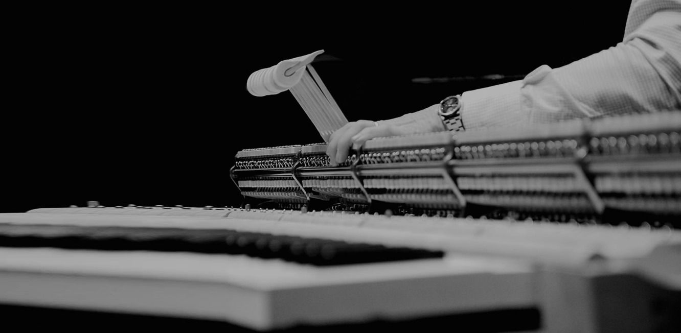 A black and white photo of a person playing a piano.