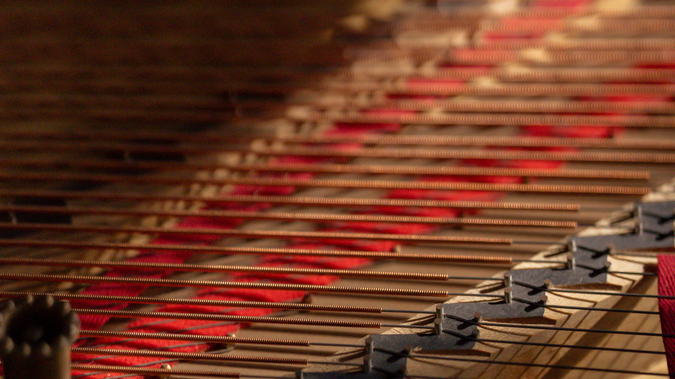 A close up of a piano keyboard with red and white keys.