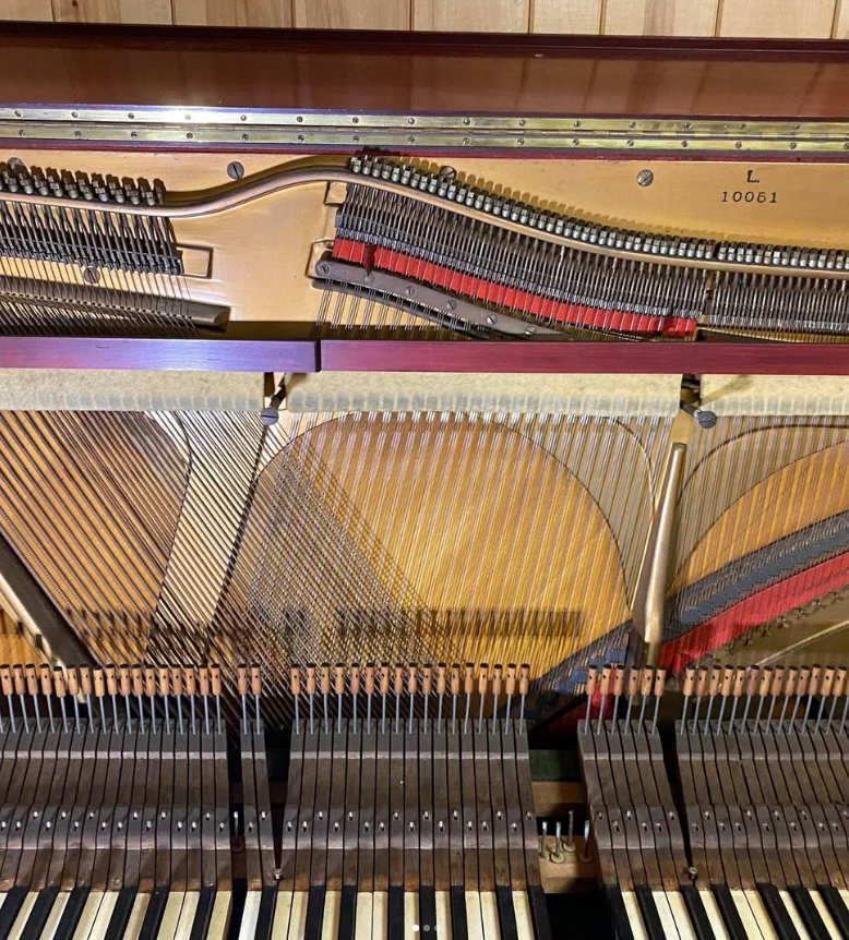 The inside of a piano with the keys visible