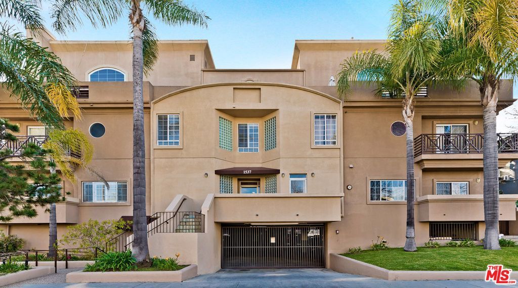 A large apartment building with a garage underneath it