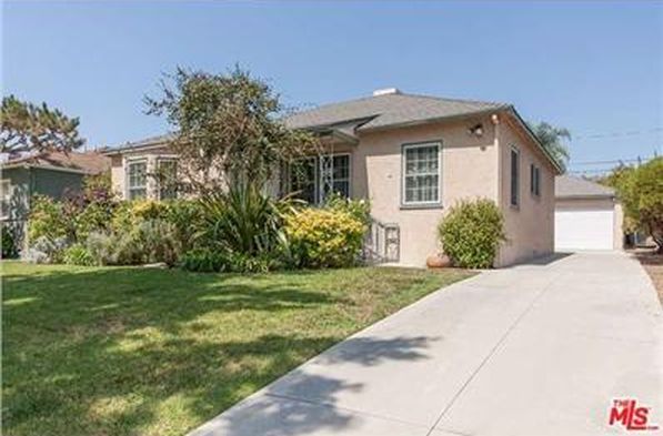 A house with a concrete walkway leading to it