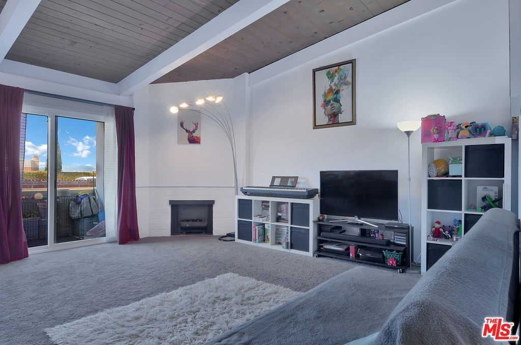 A living room with a couch and a flat screen tv