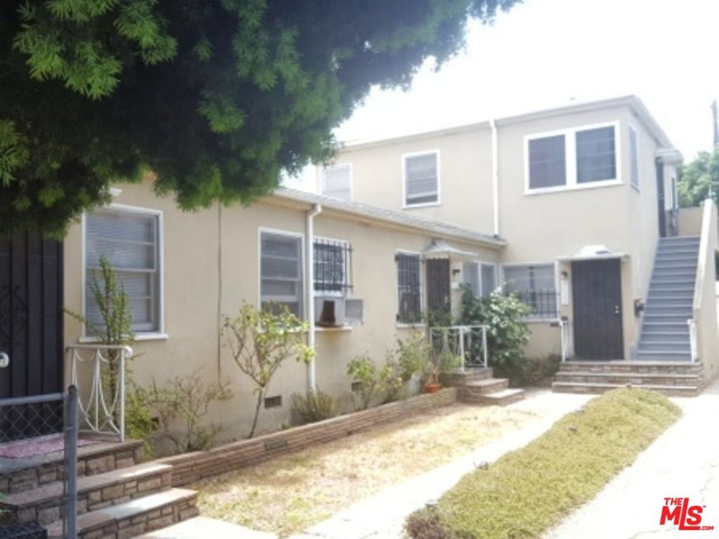 A house with stairs leading up to the second floor is for sale.