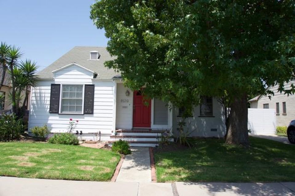 A white house with a red door and black shutters