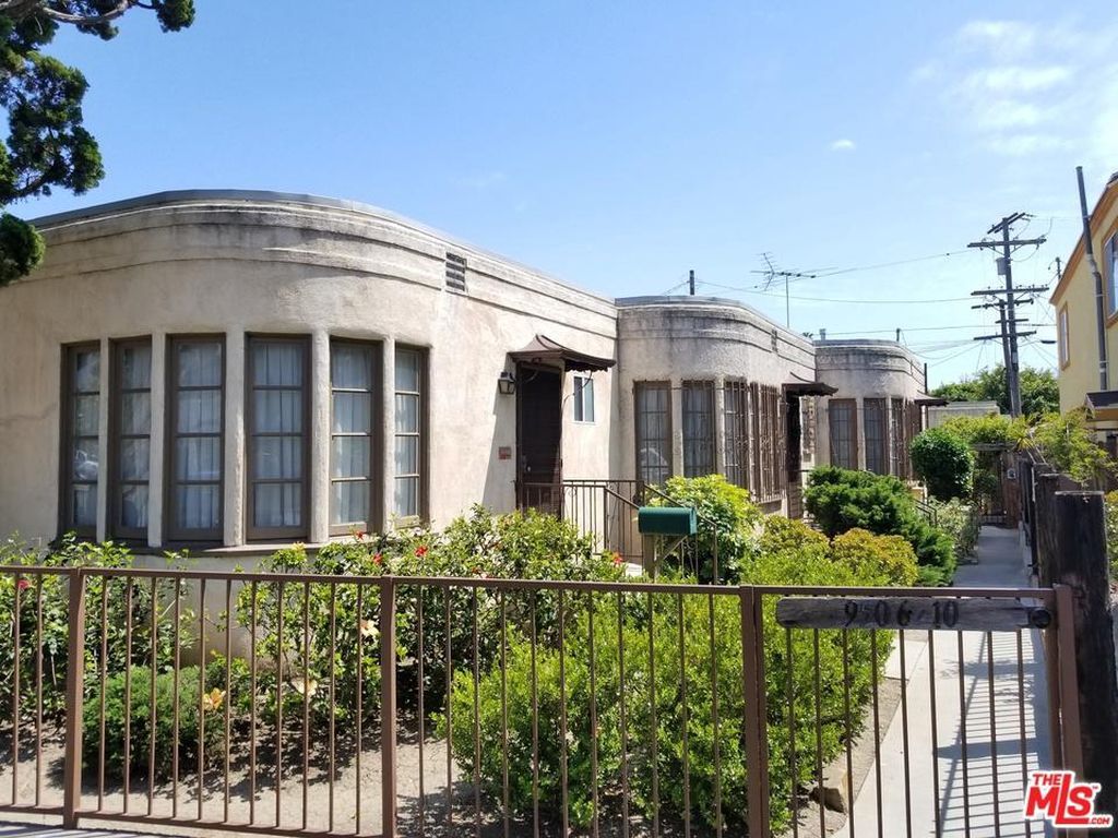 A house with a fence and a mailbox in front of it