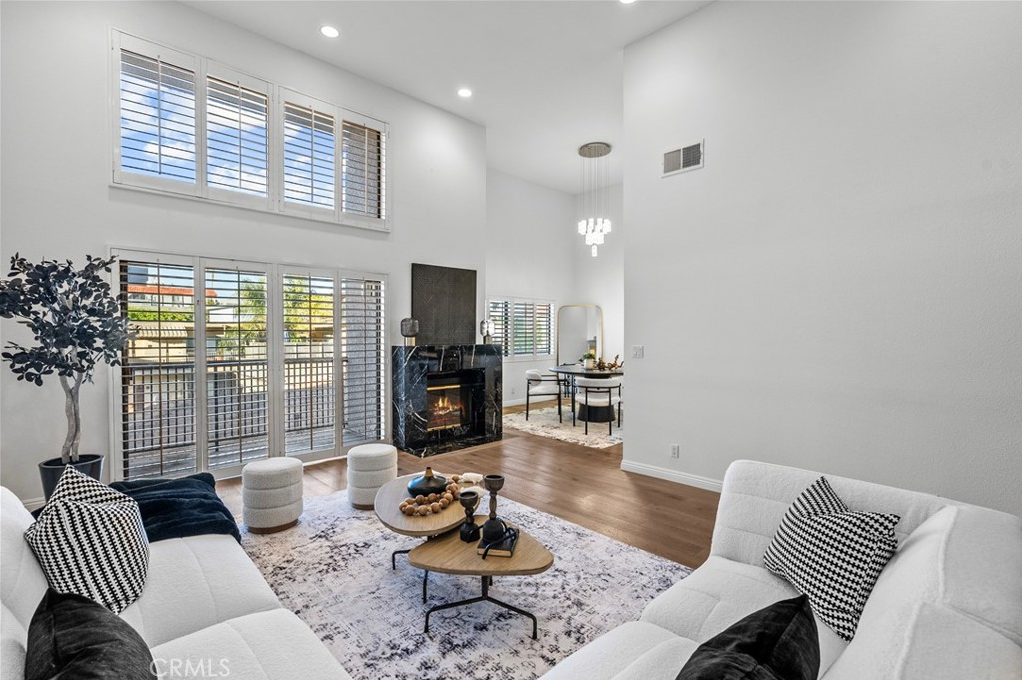 A living room with two couches , a coffee table , and a fireplace.