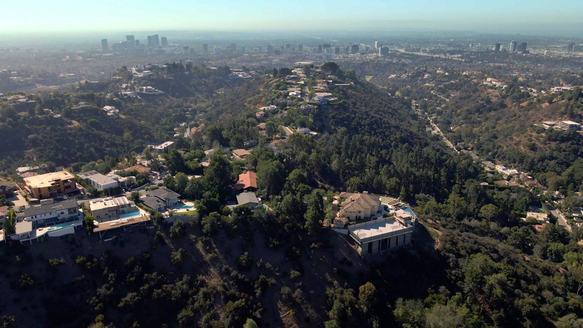 An aerial view of a residential area with a city in the background