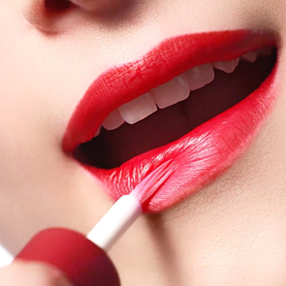 CLARINS lipstick being applied to model