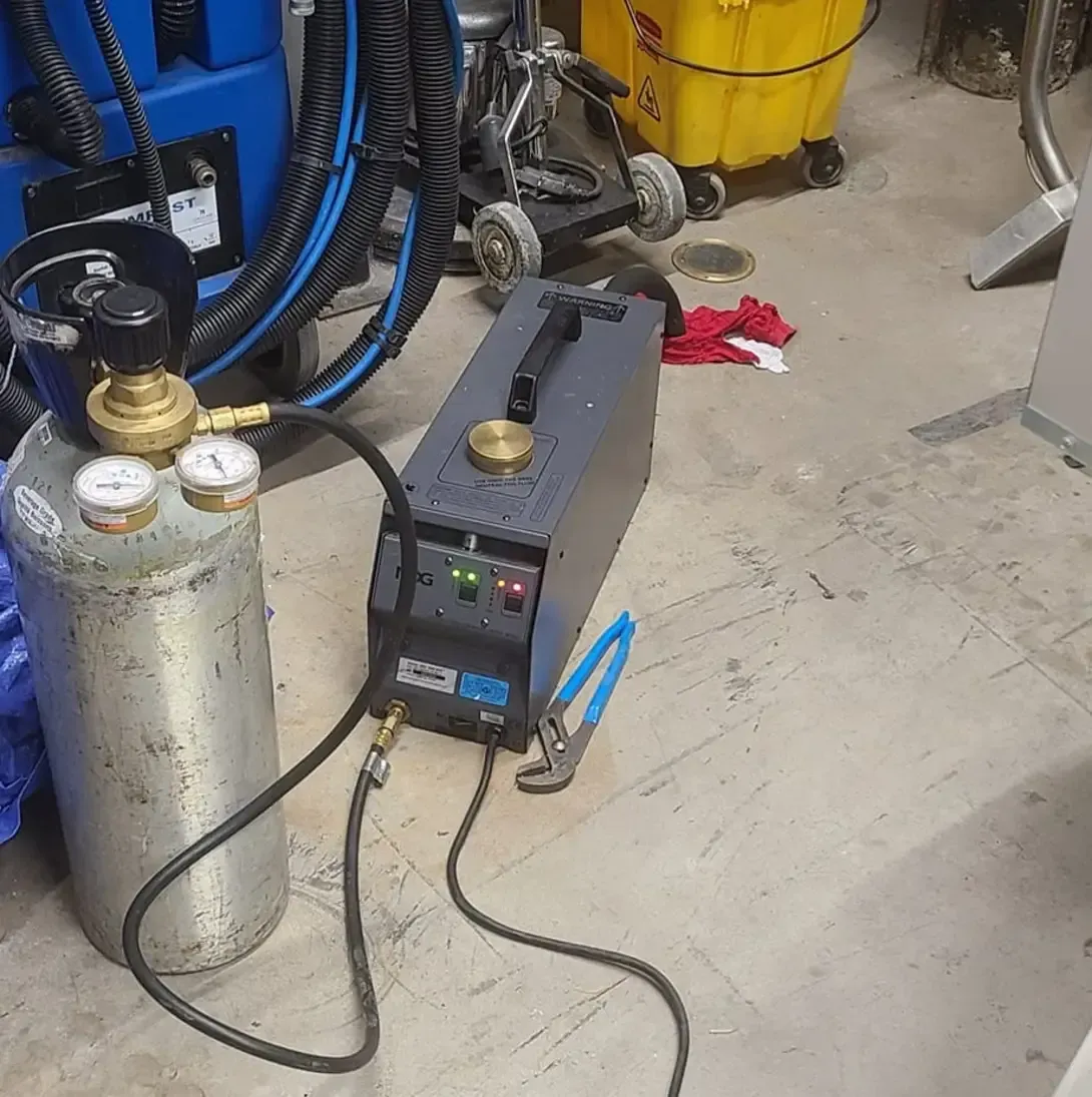 Une bouteille de gaz est connectée à une machine dans un garage
