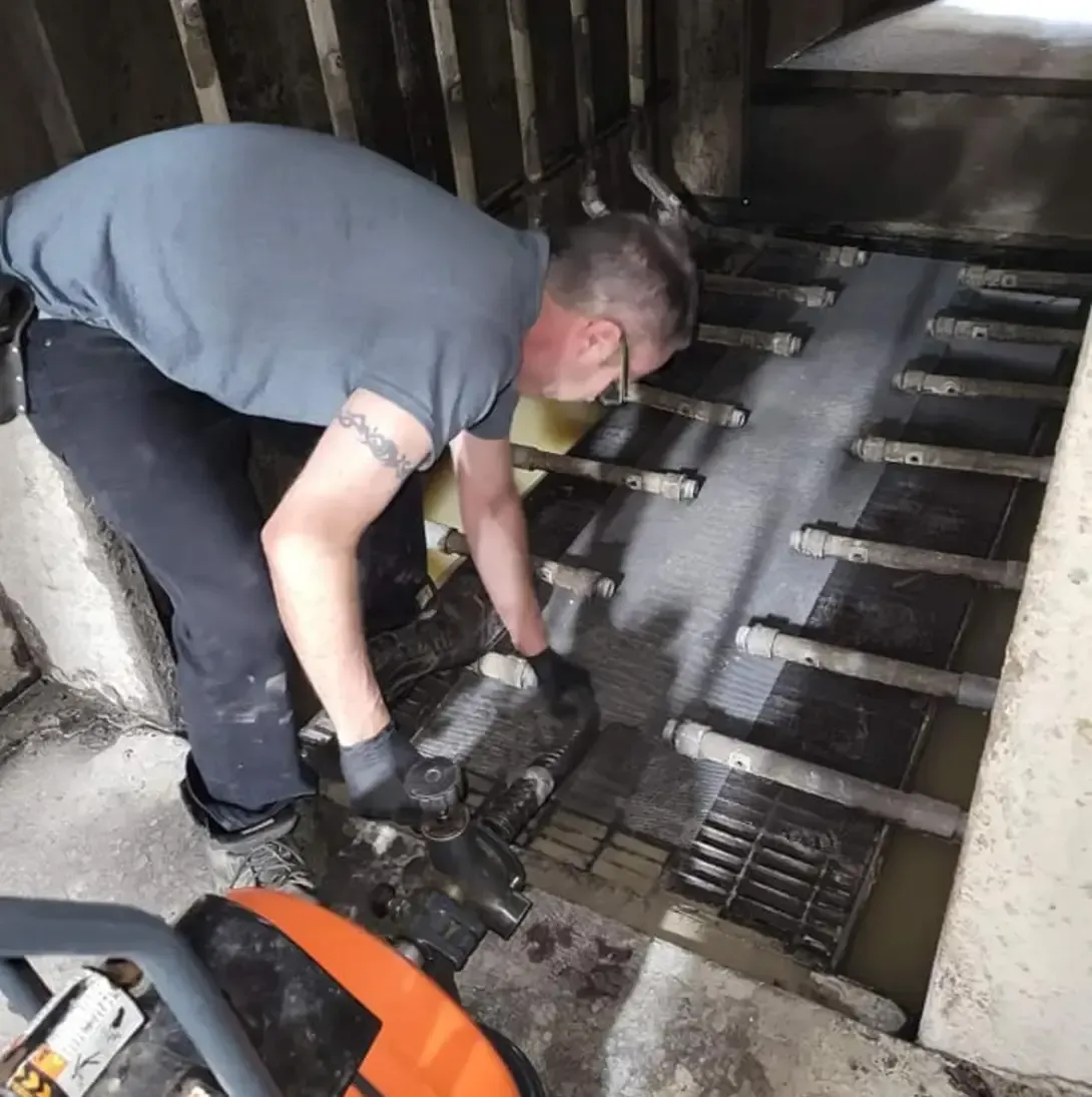 Un homme avec un tatouage sur le bras travaille sur une machine