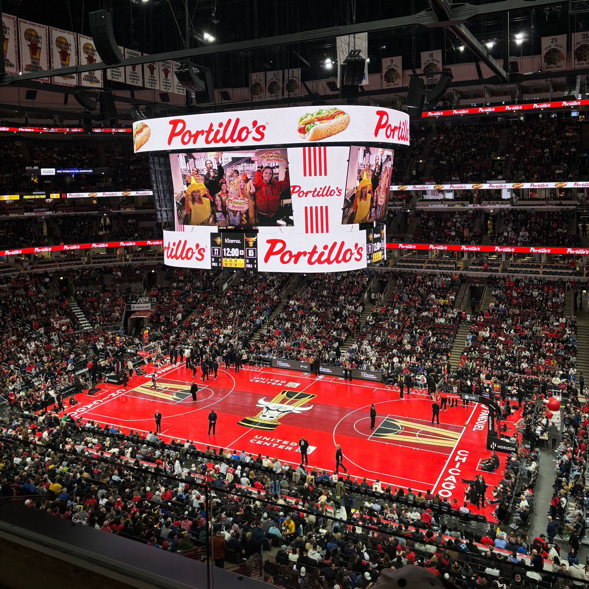 Green Bay Packers football game in progress at Lambeau Field. Large crowd in stadium, players on field.