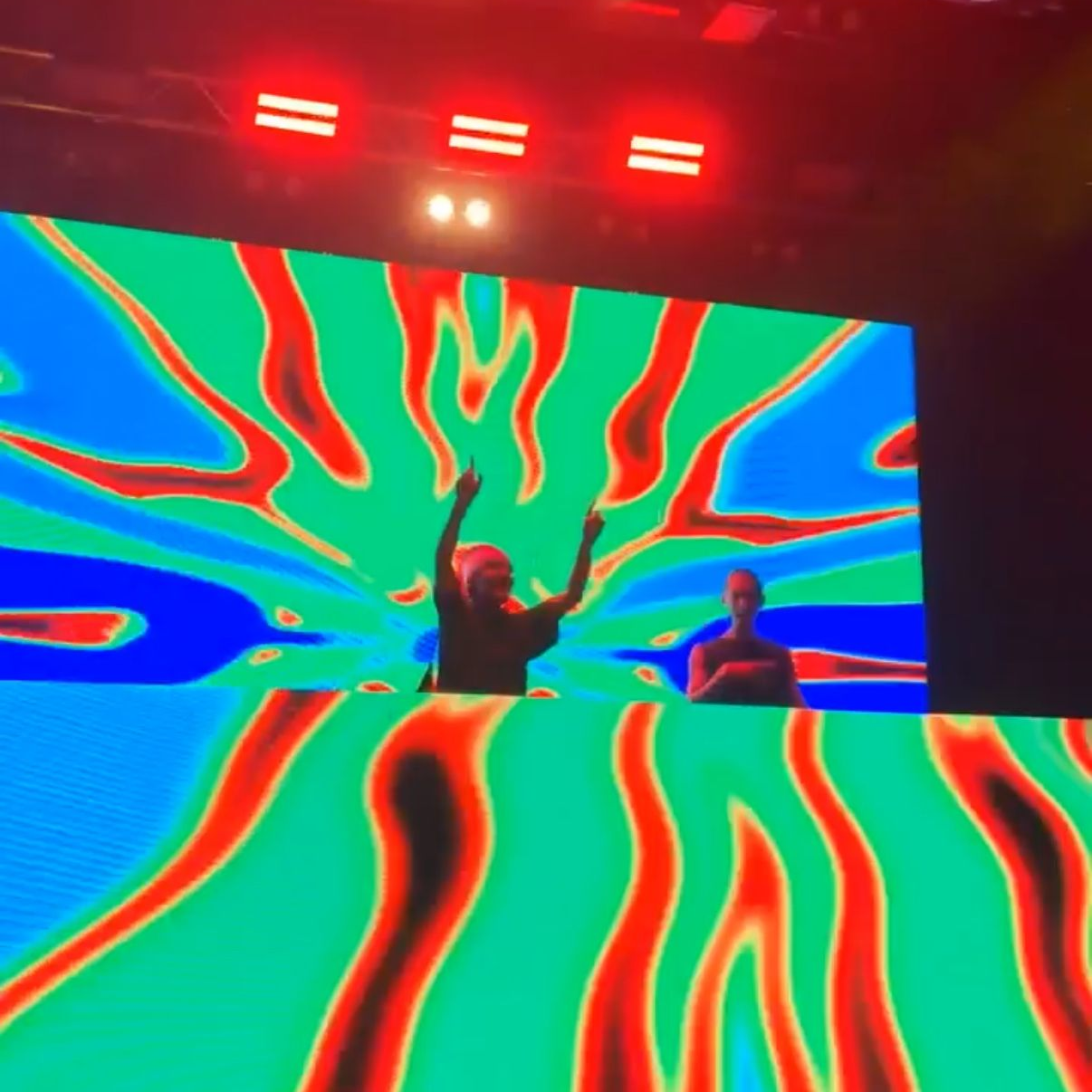 Golf course green with a golf ball in front of the red flag.