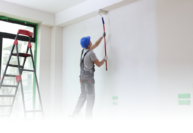 A man is painting a wall with a roller.