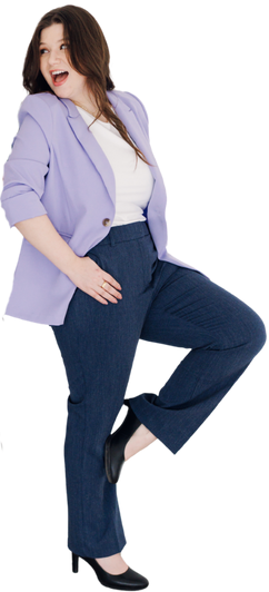 Woman in blue pantsuit, purple blazer, black shoes, standing on one leg, smiling, looking away.