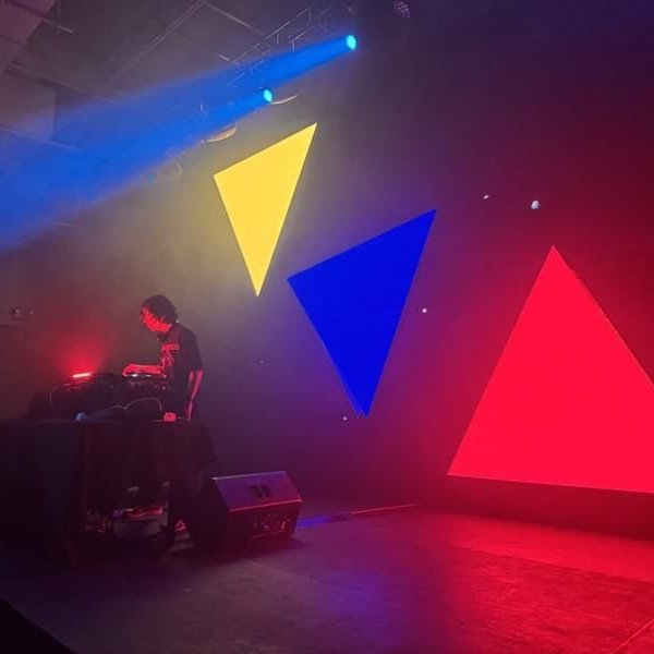 Winding path through a vibrant autumn forest, trees with red and orange leaves, fallen leaves on the ground.