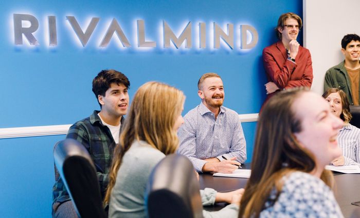 an excited group of young digital marketing experts in a conference room