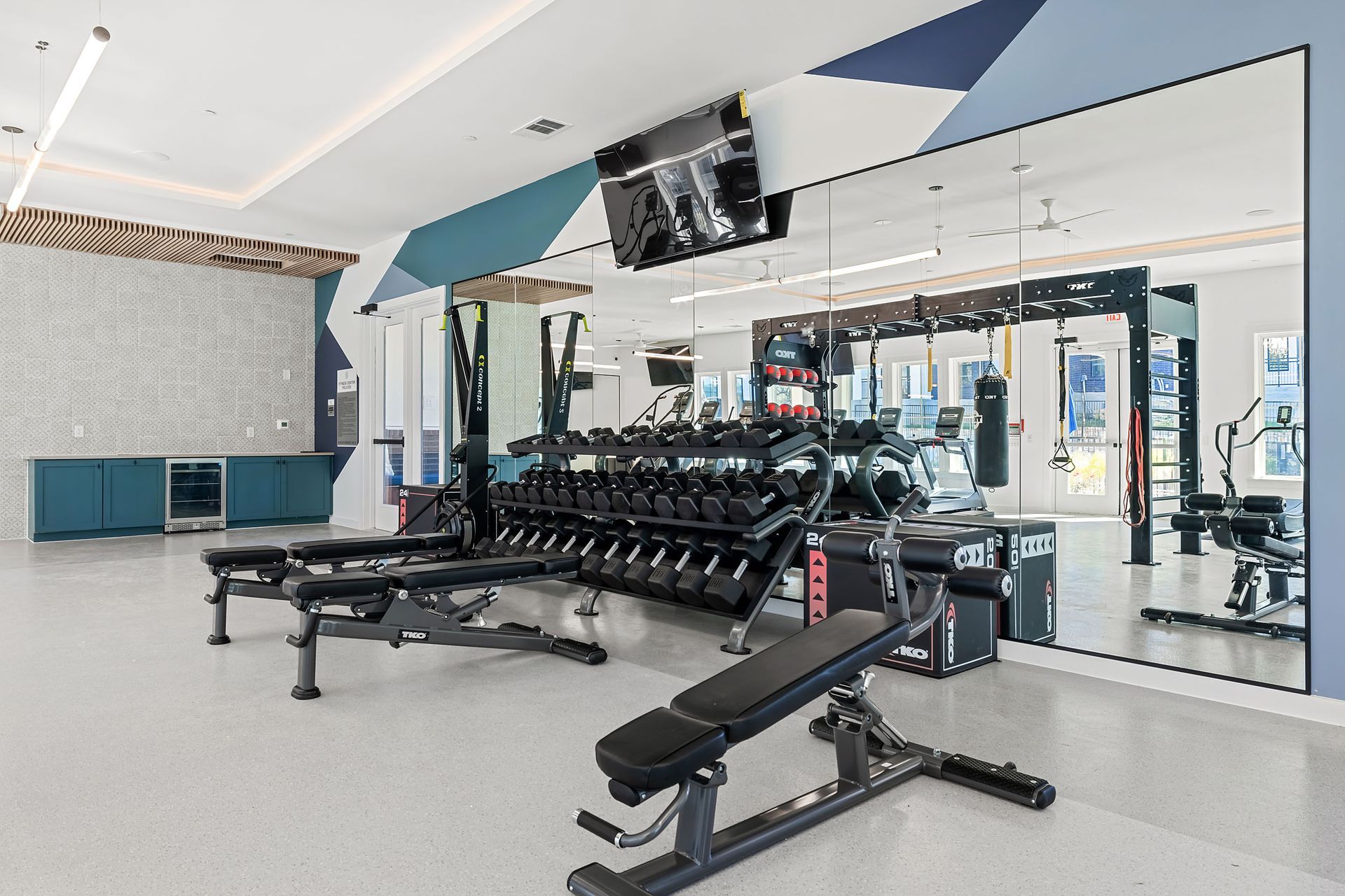 Brand new apartment gym with a lot of equipment and a large mirror at The Everett. offering apartments in Northwest Austin, TX.