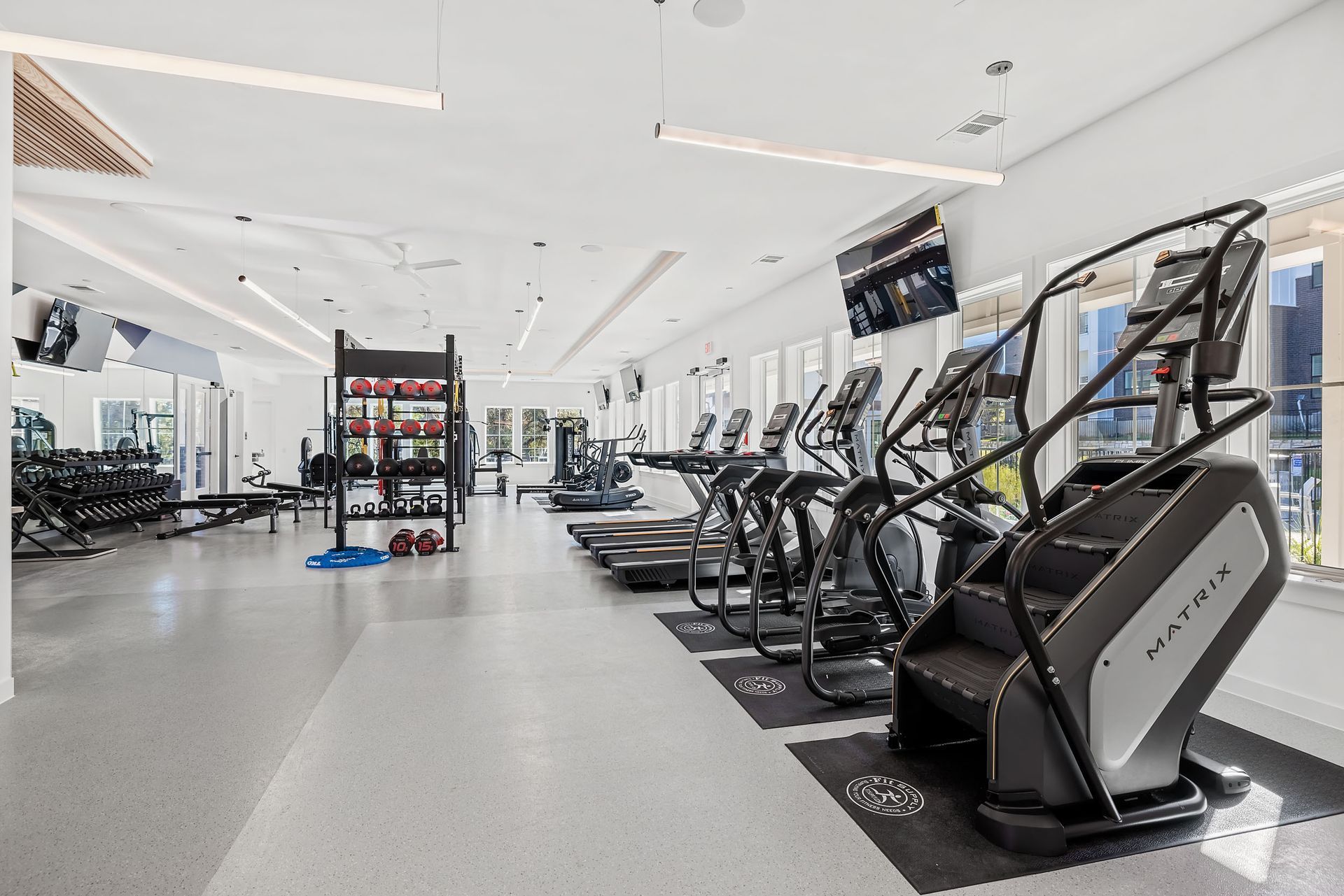 A large white building with a large outdoor yoga lawn in front of it at The Everett, offering apartments in Northwest Austin, TX.