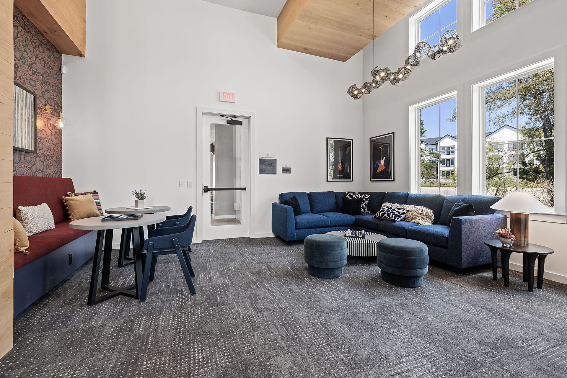 Apartment community game room with a couch, table, and chairs at The Everett, offering apartments in Leander ISD.