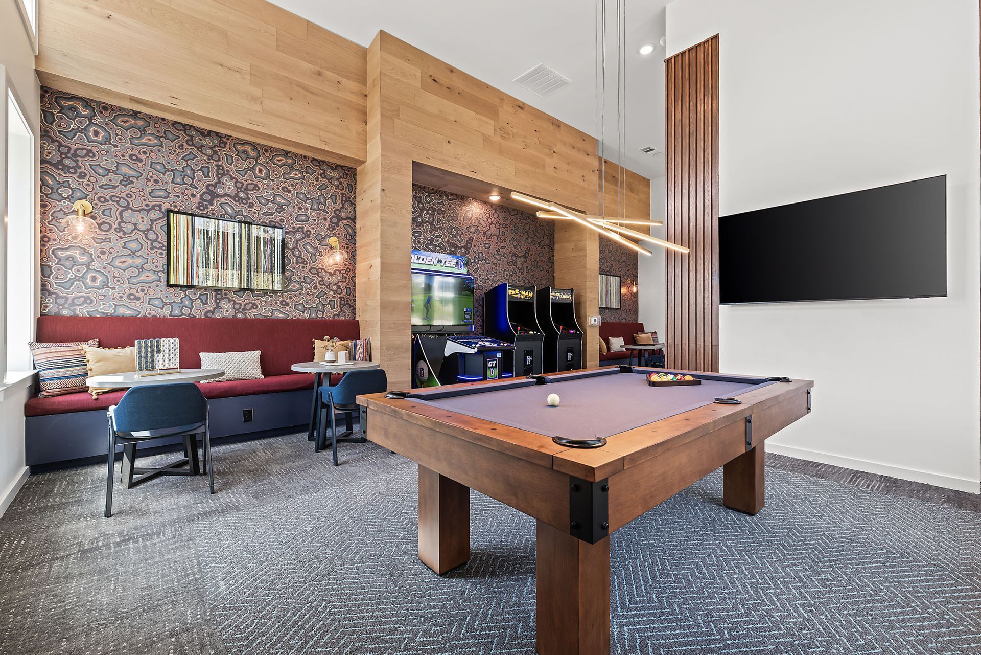 Apartment community game room with a pool table in the middle of the room at The Everett, offering apartments for rent in North Austin.