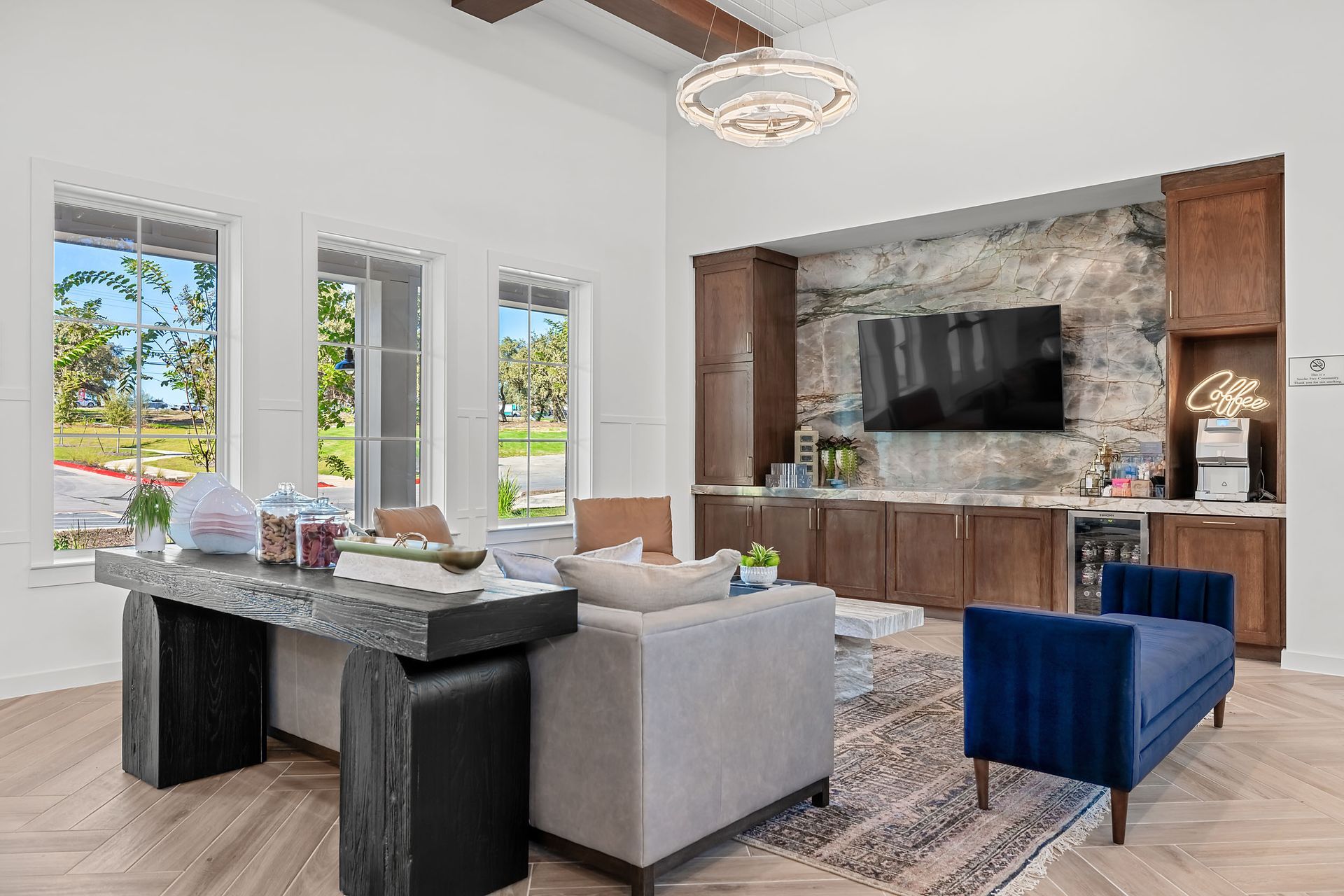 A modern clubhouse filled with furniture and a flat-screen tv at The Everett. offering apartments in Northwest Austin, TX.