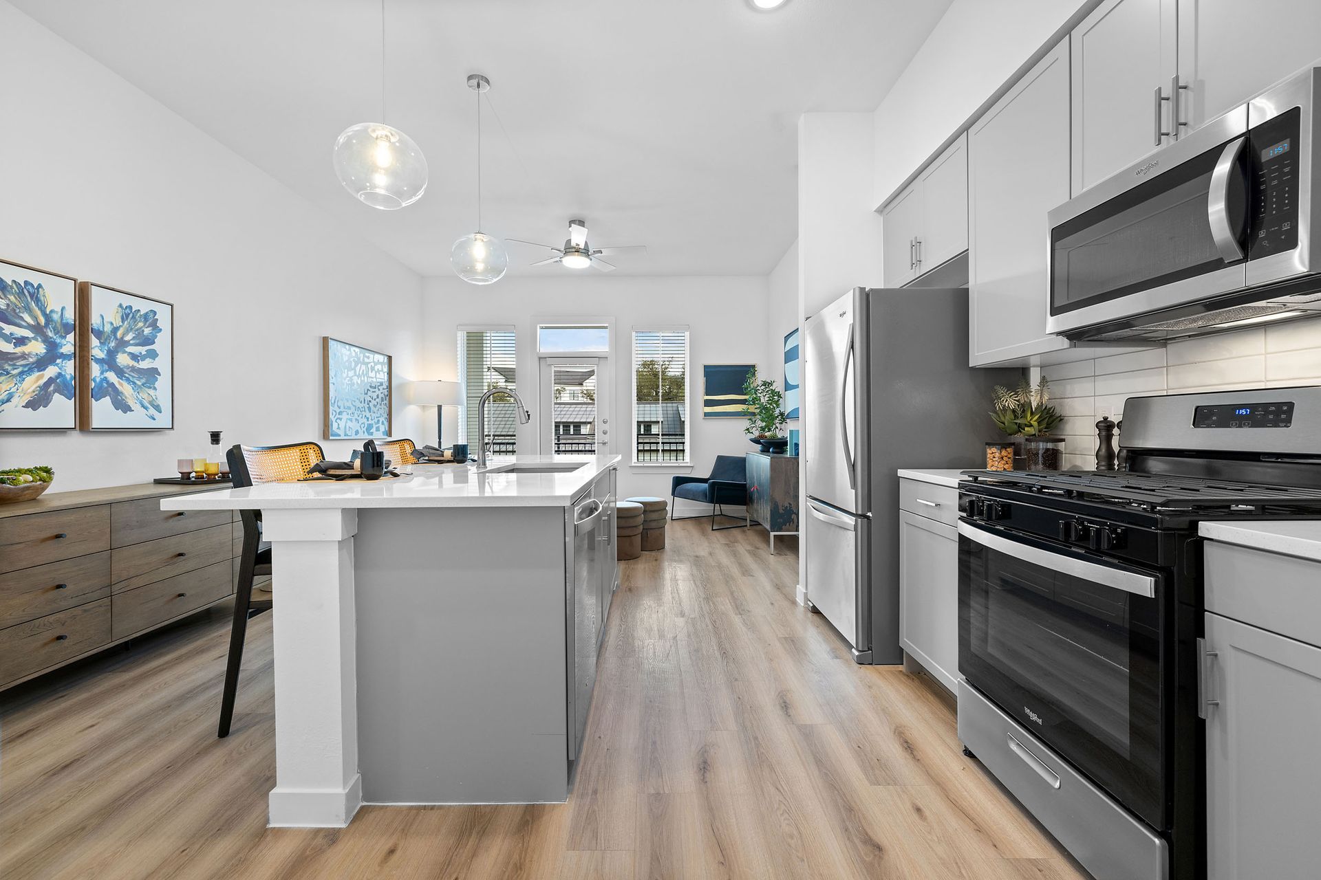 A kitchen with stainless steel appliances and a large island at The Everett, offering apartments for rent in Northwest Austin, TX.