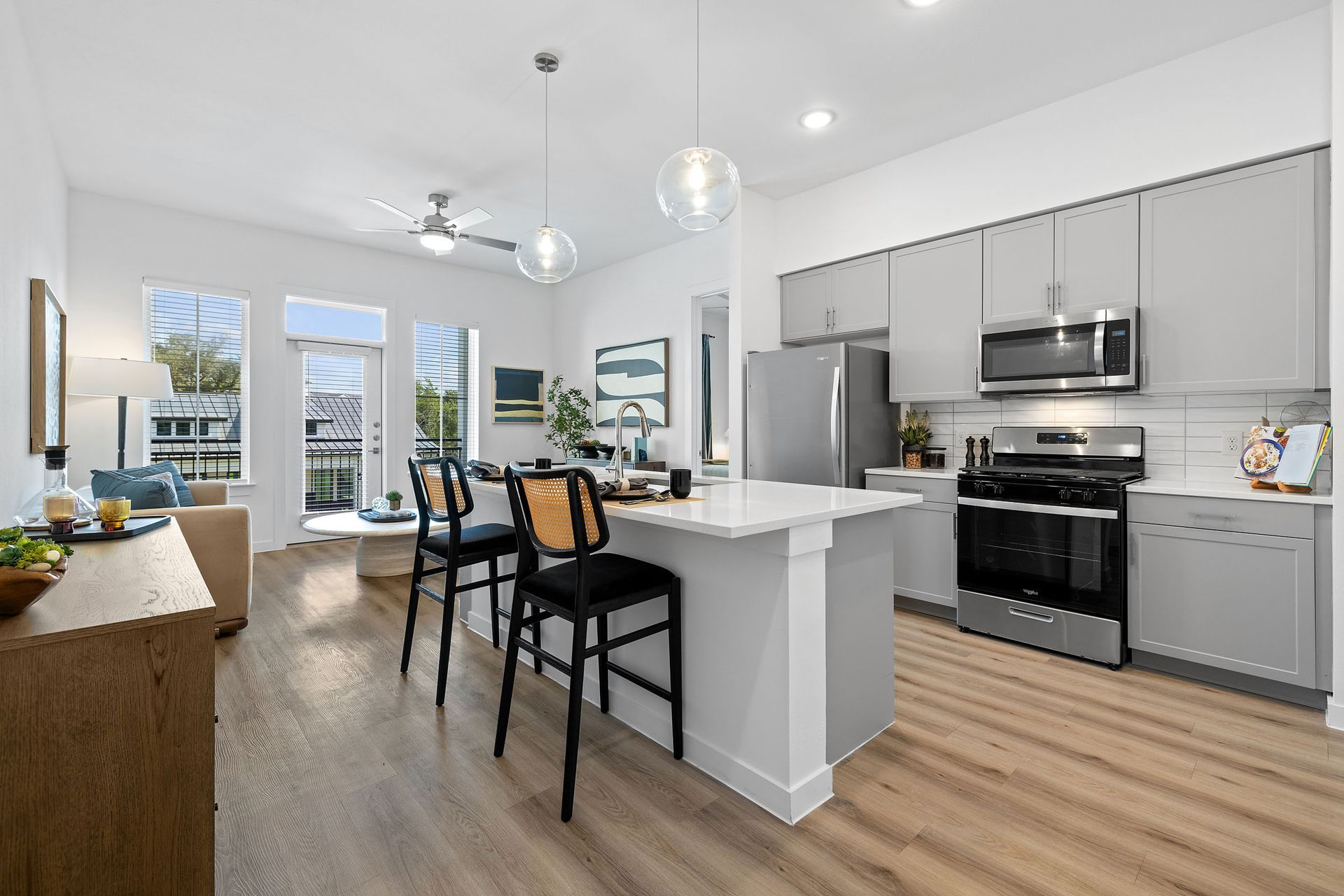 A large lush green field with trees in the background at The Everett, offering apartments for rent with private fenced yards.