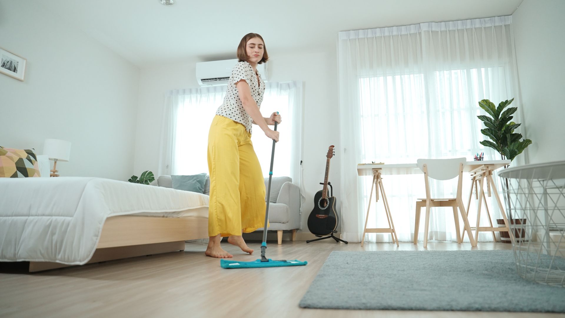 Open moving truck filled with boxes and furniture in front of a house.