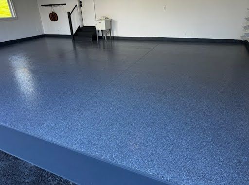 Garage with a shiny, dark blue epoxy floor.