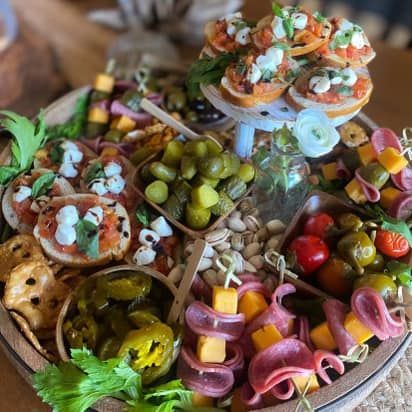 A wooden barrel filled with a variety of food on a table.