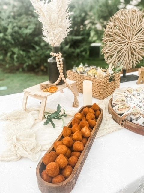 A wooden bowl filled with fried food is on a table.