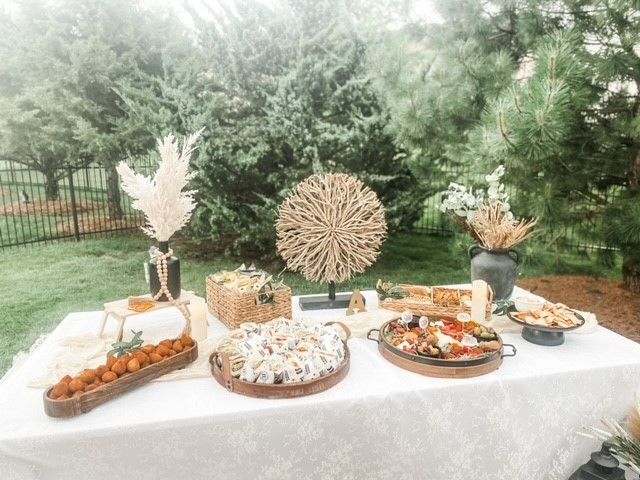 A table with a lot of food on it is sitting in the grass.
