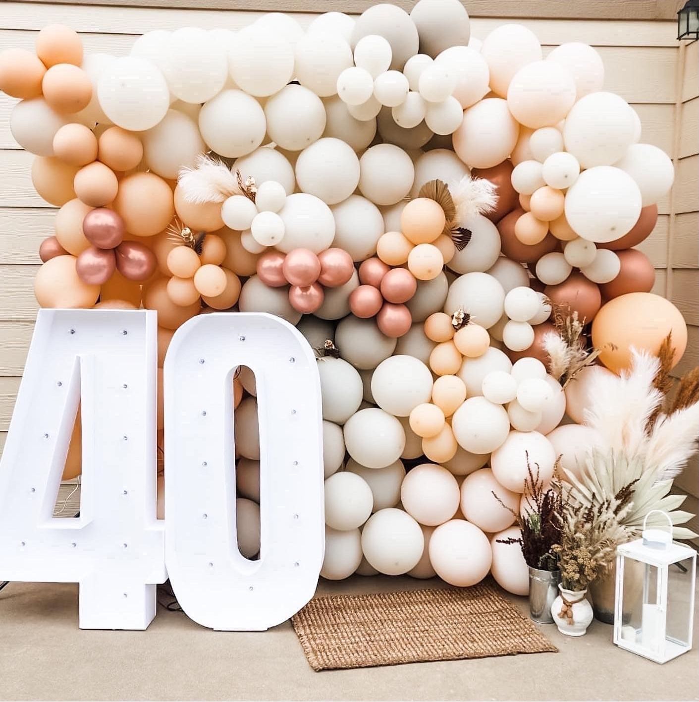 A wall of balloons with the number 40 in front of it