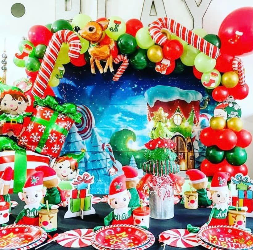 A table decorated for a christmas party with plates and balloons