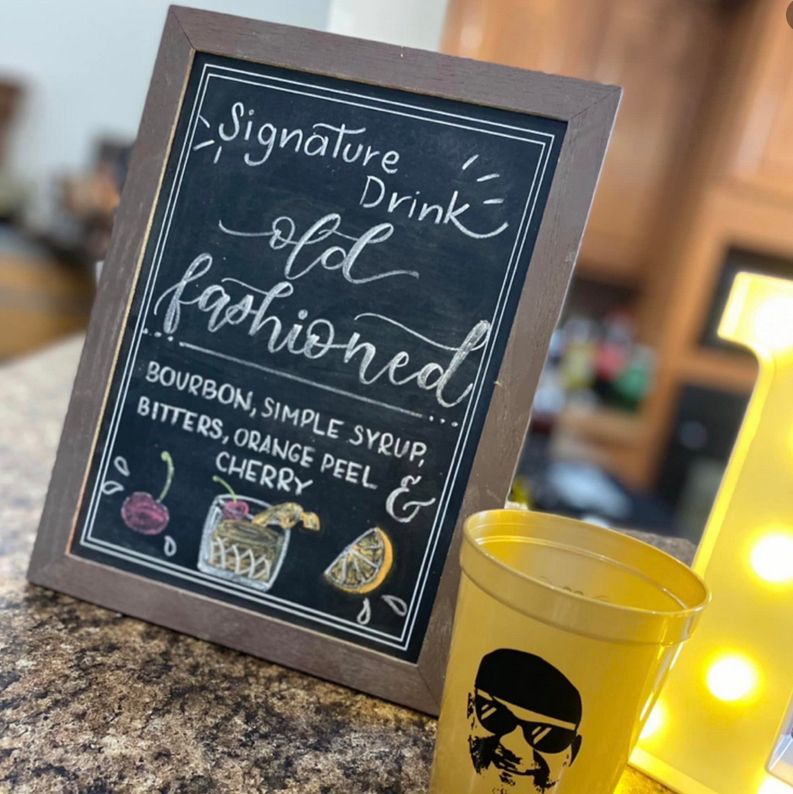 A sign that says signature drink old fashioned on it