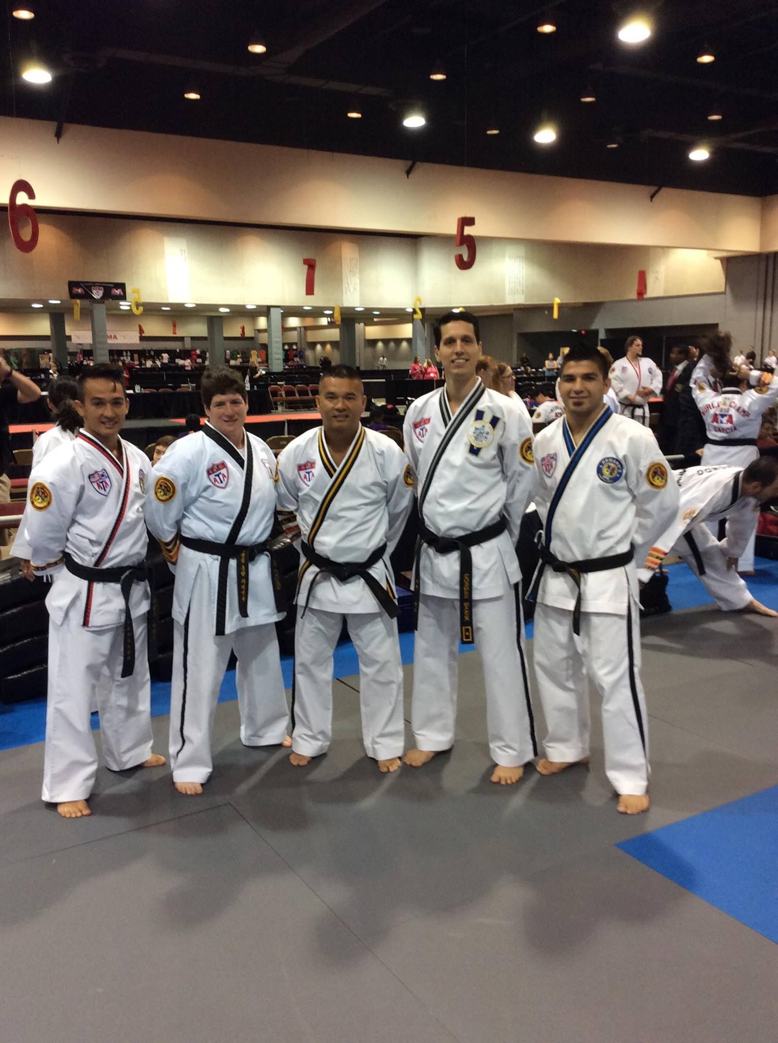 A group of men in karate uniforms pose for a picture