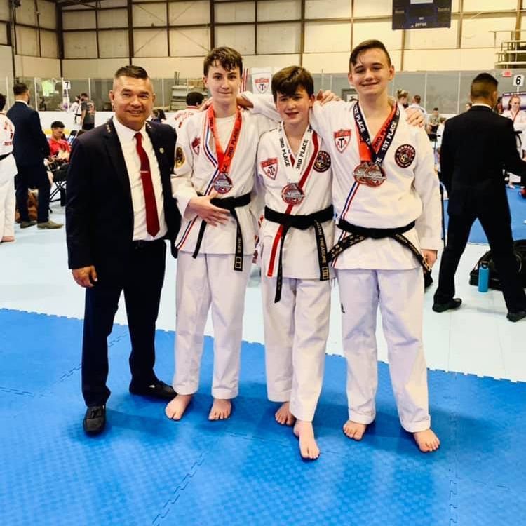 A group of young men are posing for a picture with medals around their necks
