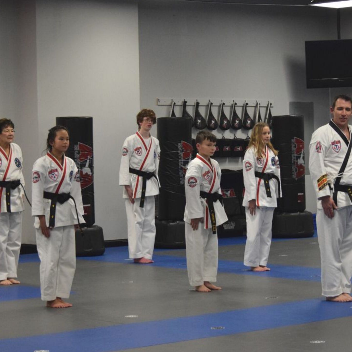 A group of people in karate uniforms are standing in a line