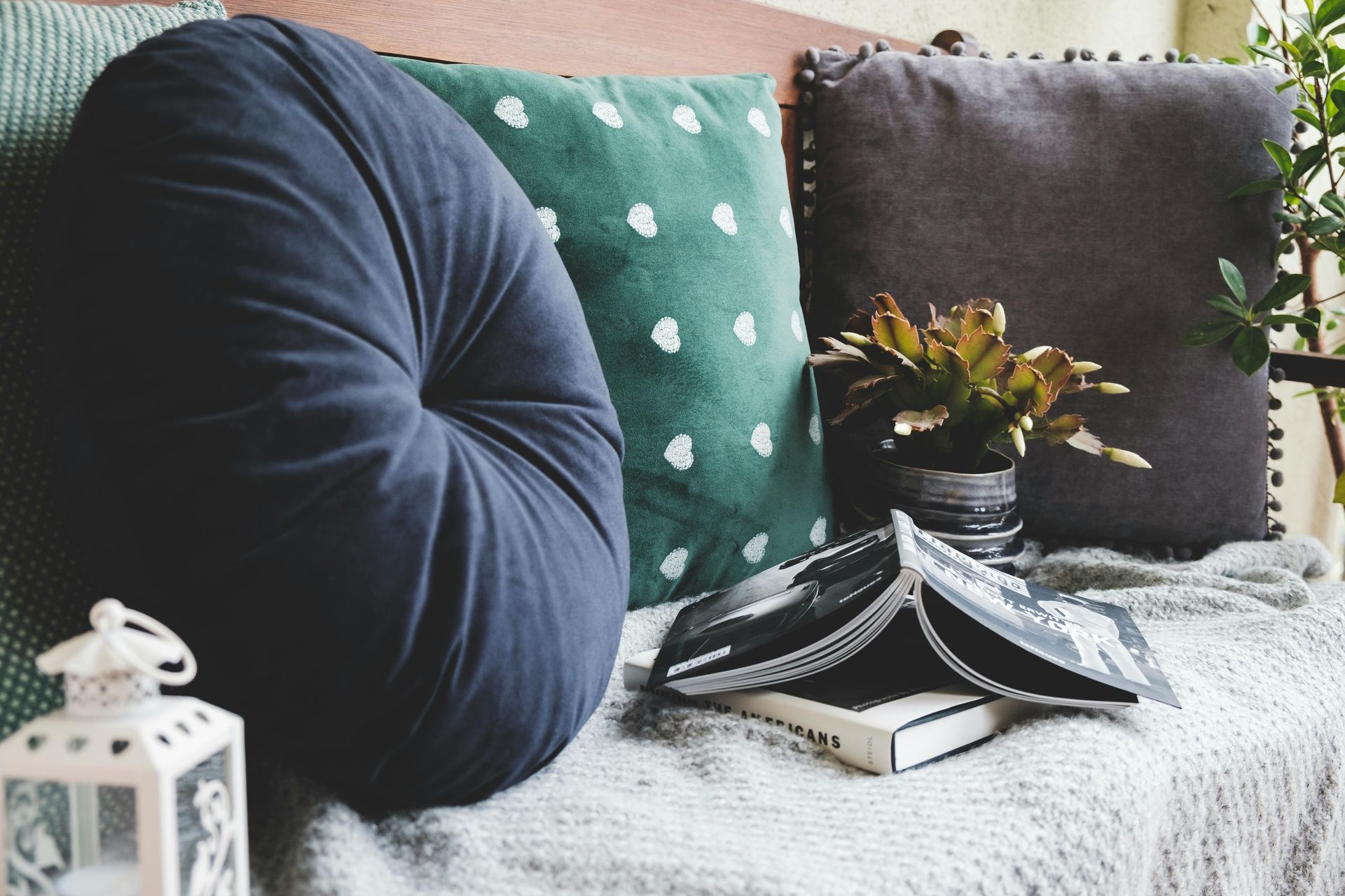 A couch with pillows and a book on it.