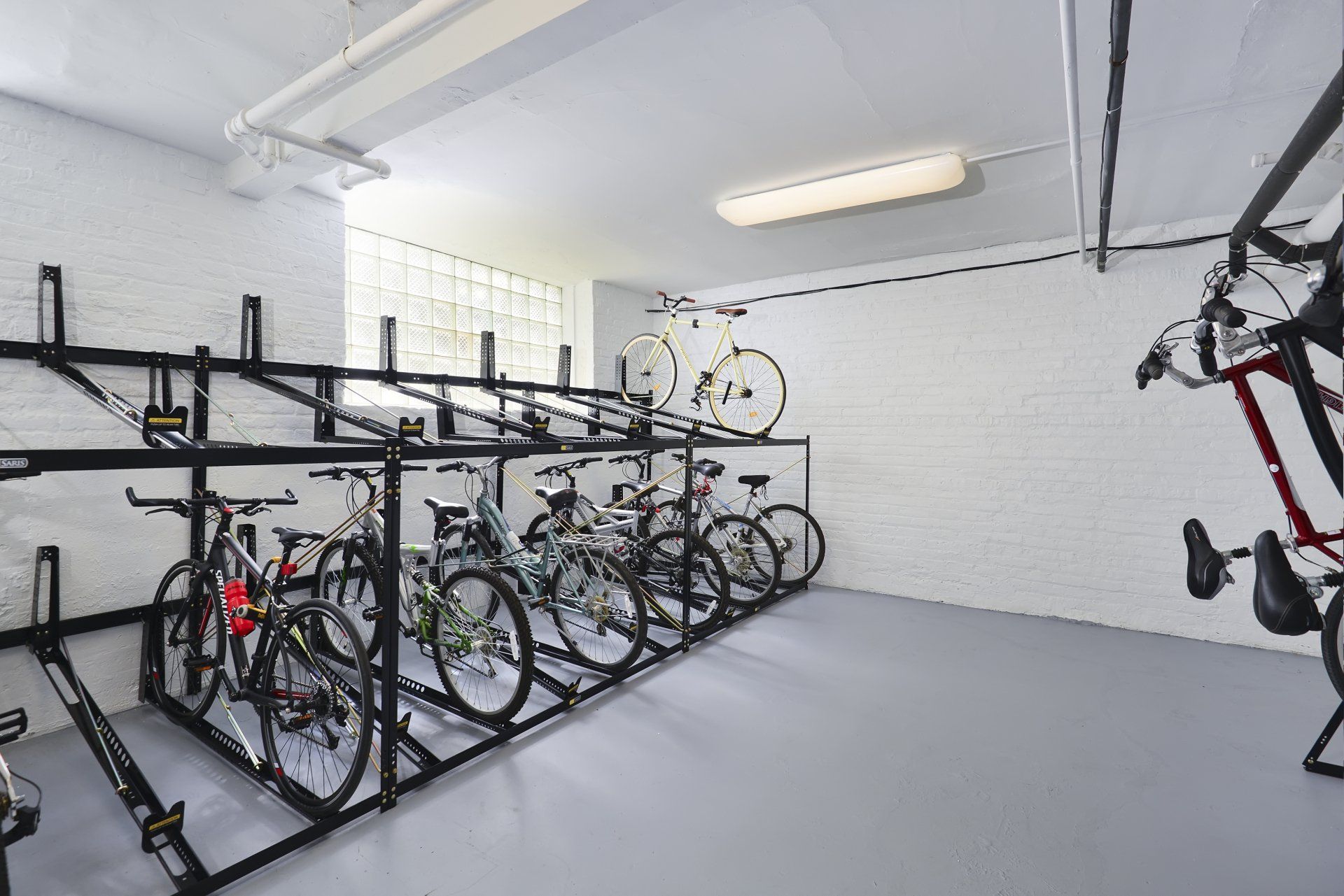 A row of bicycles are lined up in a bike storage at Irving Courts by Reside.
