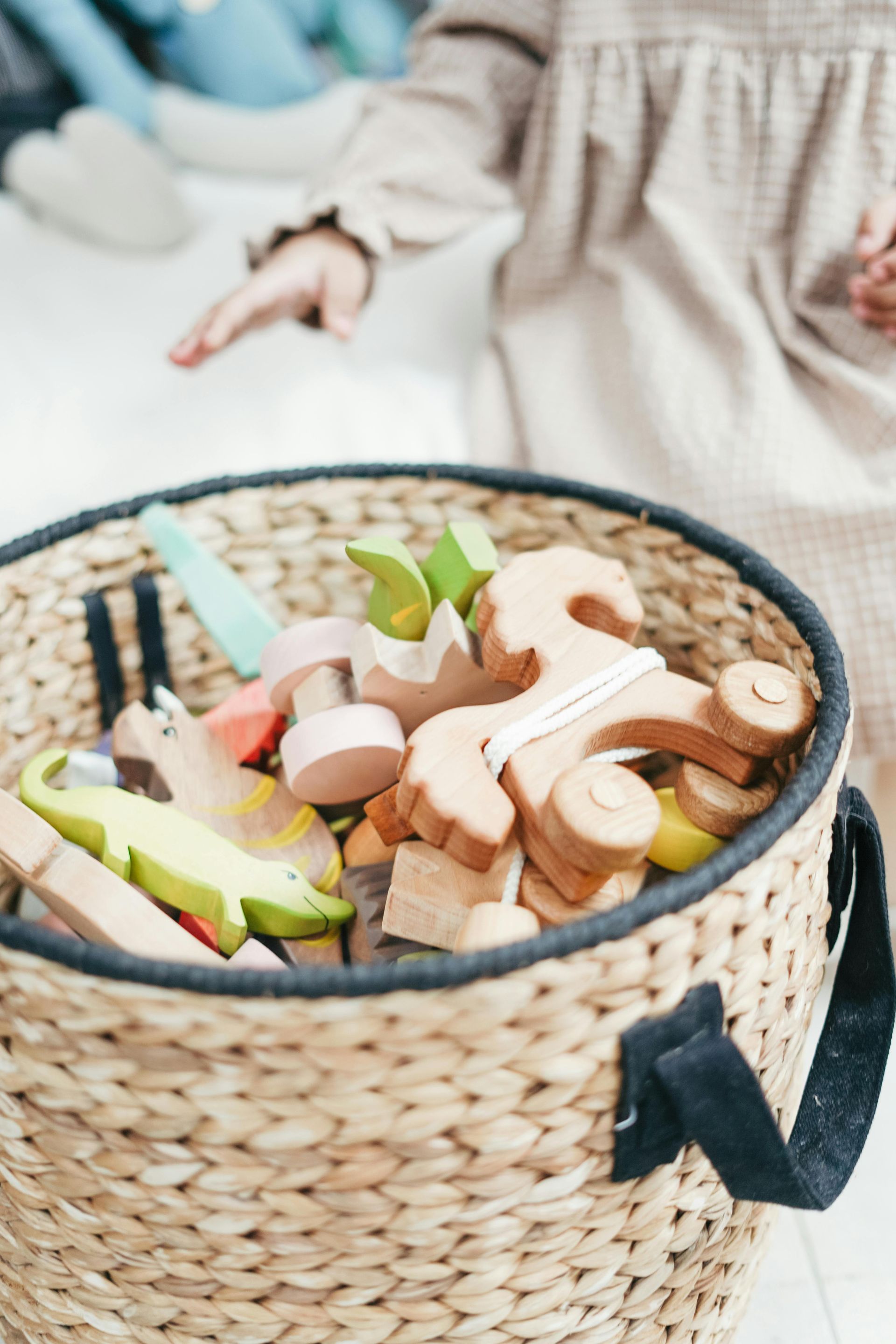 woven wicker basket full of wooden colourful toys