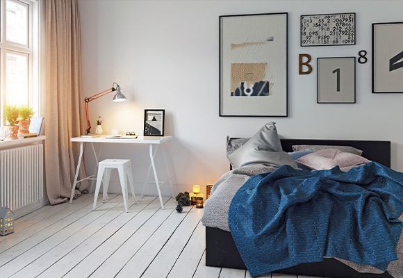 A bedroom with a bed and a desk with numbers on the wall
