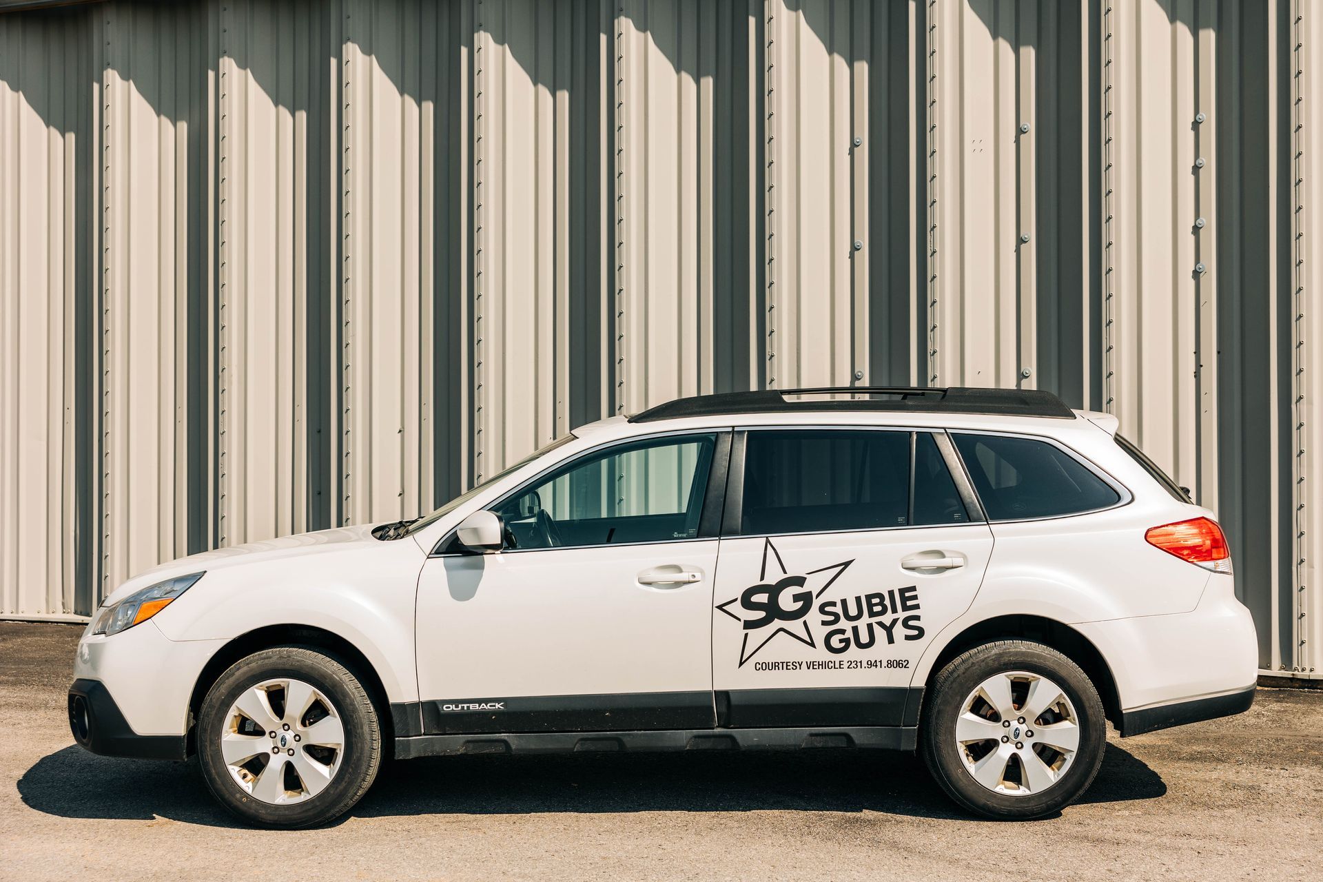 White Subaru Outback with 